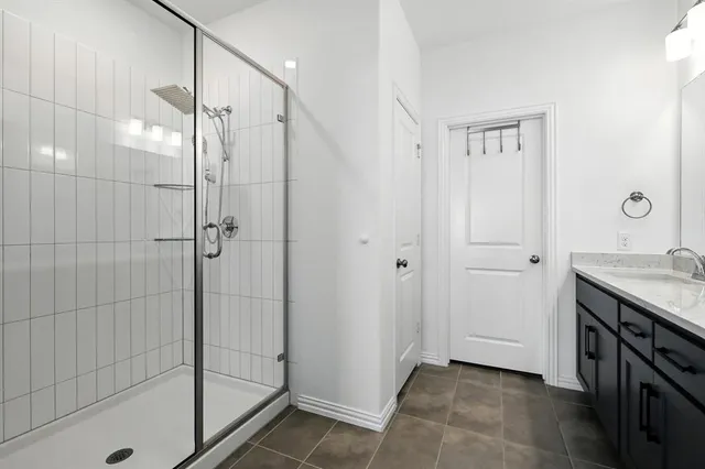 a bathroom with a granite countertop shower mirror and a sink