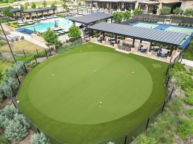 an aerial view of a tennis ground with large trees