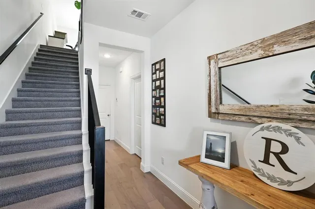 a view of staircase with white walls and railing