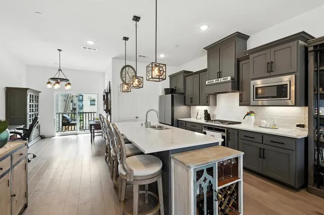 a large kitchen with a table and chairs