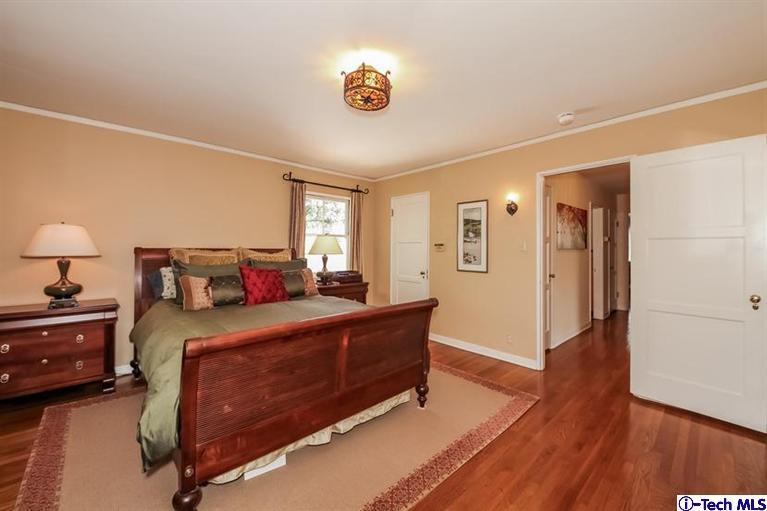 1963 New York Drive Altadena, CA 91001 - Photo 15 of 38 a bed room with a bed and a lamp