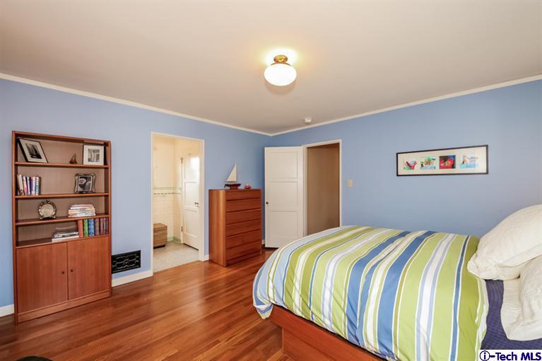 1963 New York Drive Altadena, CA 91001 - Photo 19 of 38 a bedroom with a bed and a flat screen tv