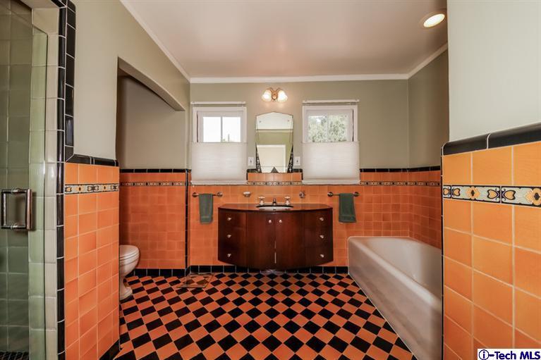 1963 New York Drive Altadena, CA 91001 - Photo 22 of 38 a bathroom with a bathtub a sink and a shower