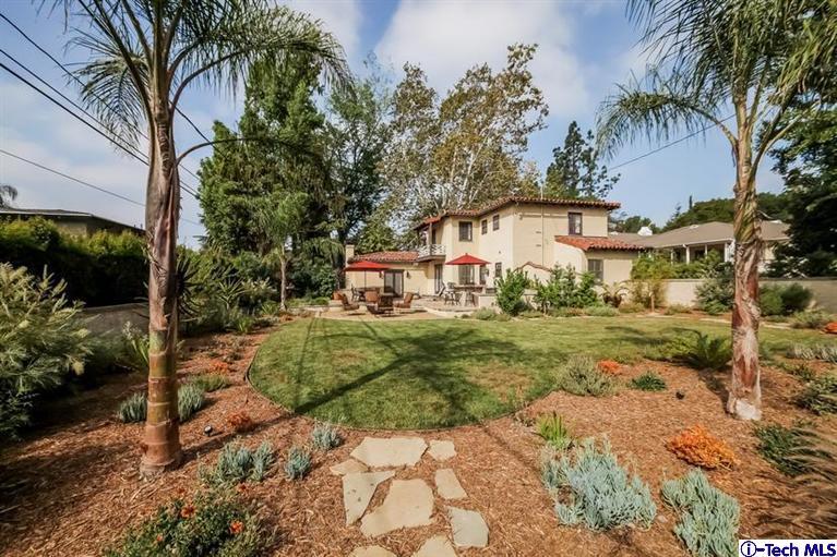 1963 New York Drive Altadena, CA 91001 - Photo 33 of 38 a view of a white house with a yard and potted plants