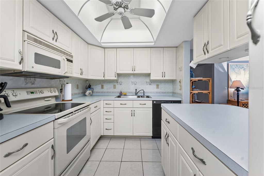 2955 North Beach Road, Unit B614 Englewood, FL 34223 - Photo 20 of 67 a kitchen with cabinets appliances and a counter space