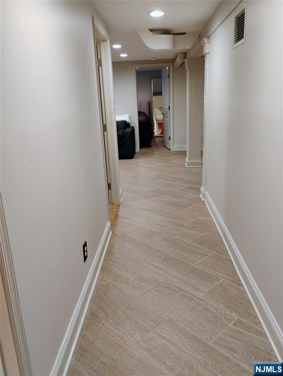 9 Harris Place, Unit 1X Fair Lawn, NJ 07410 - Photo 14 of 18 a view of a hallway with a refrigerator