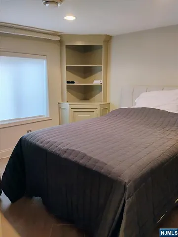 a bedroom with a bed and cabinet
