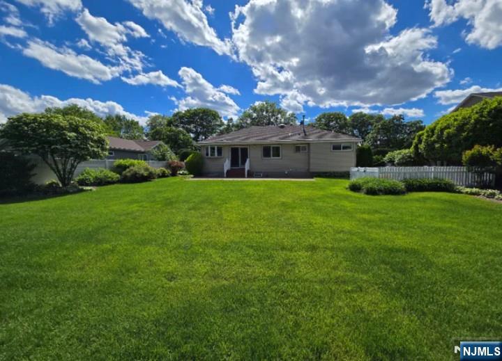 9 Harris Place, Unit 1X Fair Lawn, NJ 07410 - Photo 2 of 18 a view of a house with a big yard