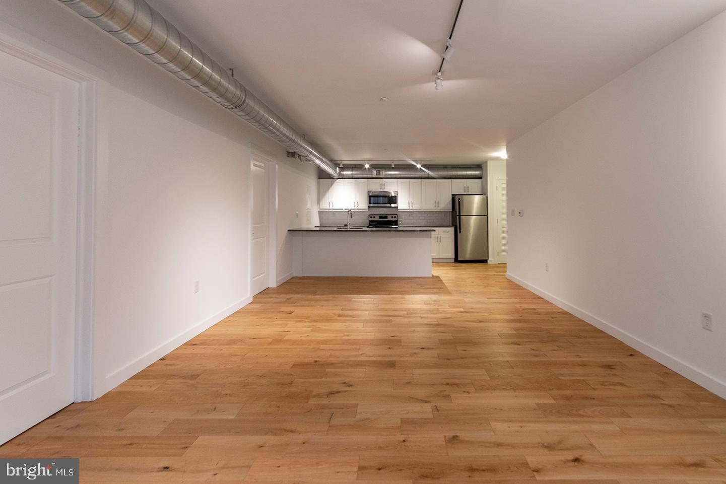 224 Church Street, Unit 215 Philadelphia, PA 19106 - Photo 4 of 15 a view of empty room with wooden floor