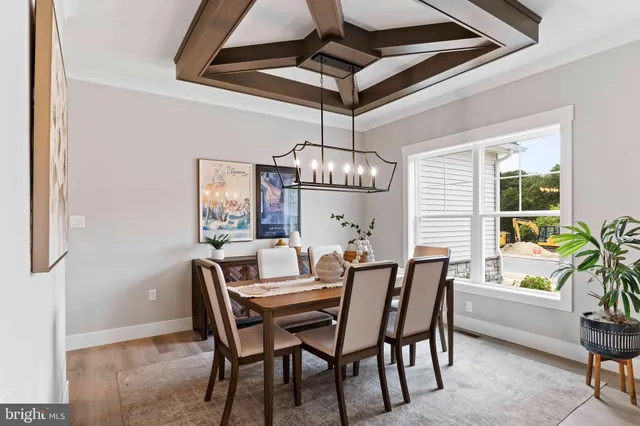 a dining room with stainless steel appliances kitchen island a table and chairs