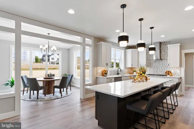 a kitchen with stainless steel appliances granite countertop a sink and a stove