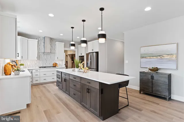 a view of kitchen cabinets with food items with white countertops
