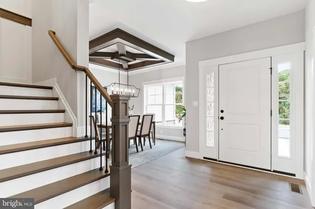 a view of entryway and hall with wooden floor