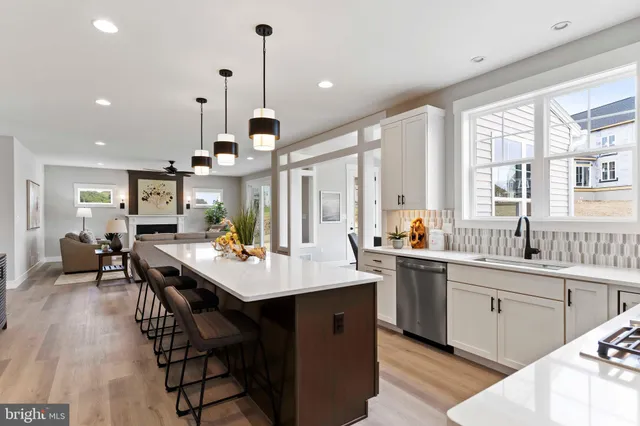 a view of a dining room with furniture a chandelier and wooden floor