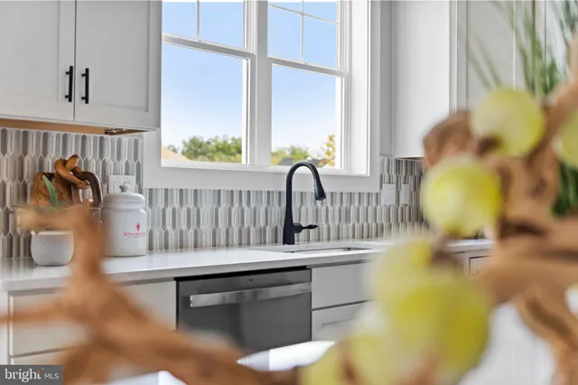 a living room with furniture fireplace and a large window