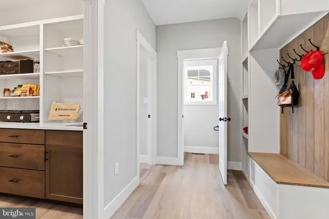 a living room with a fireplace and potted plants