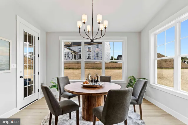 a spacious bedroom with a bed and a chandelier