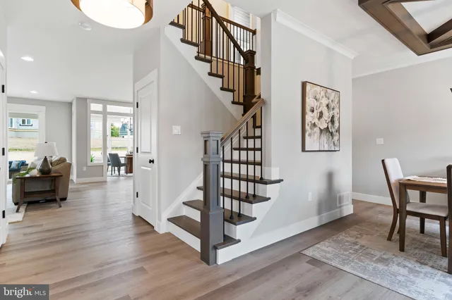 a view of entryway livingroom and hall with wooden floor