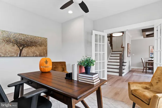 a view of a workspace with furniture and wooden floor