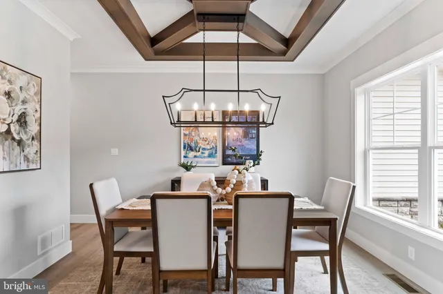 a dining room with furniture a chandelier and window