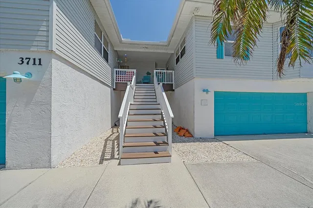 a large kitchen with cabinets a sink a counter space and stainless steel appliances