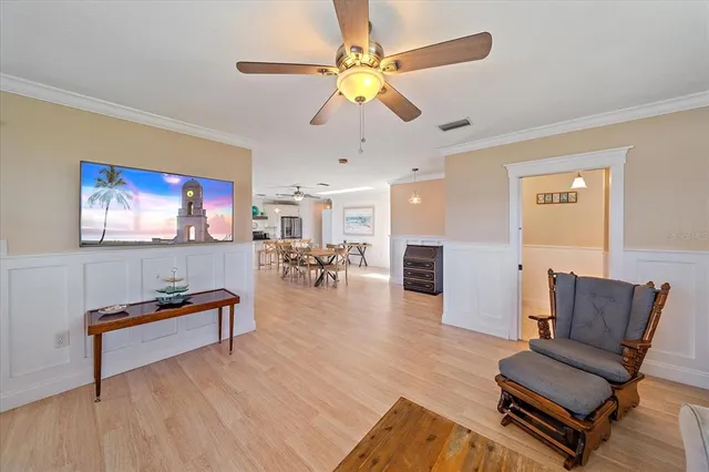 a view of a bedroom with wooden floor and furniture