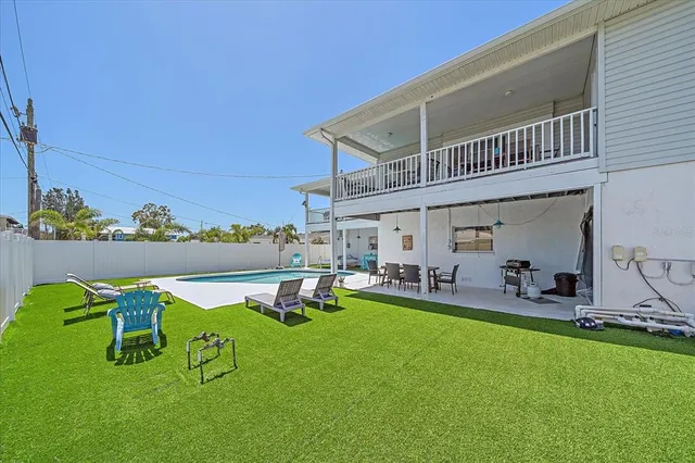 a view of a backyard with sitting area