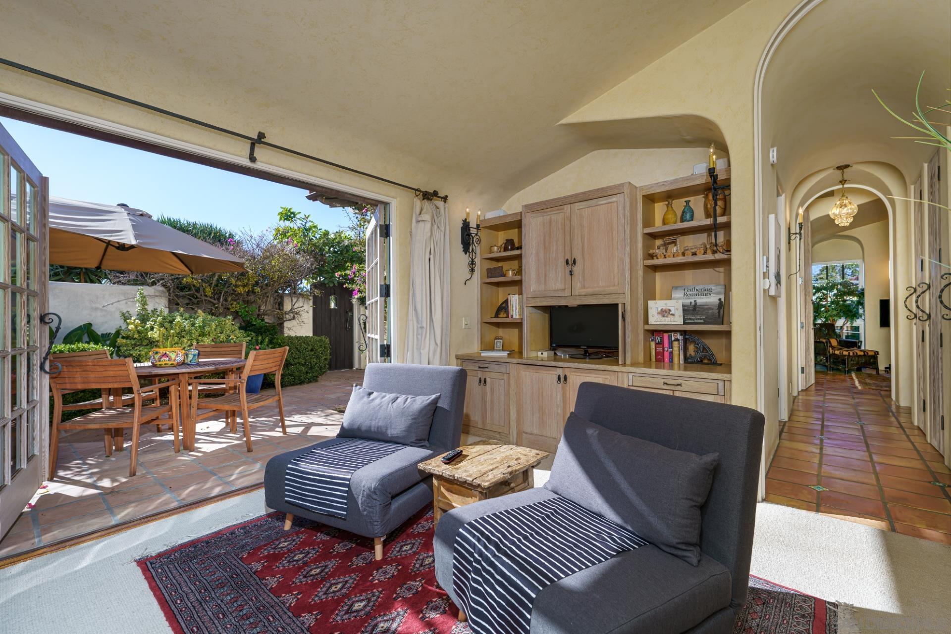 6174 El Tordo Rancho Santa Fe, CA 92067 - Photo 48 of 58 a living room with furniture fireplace and a large window