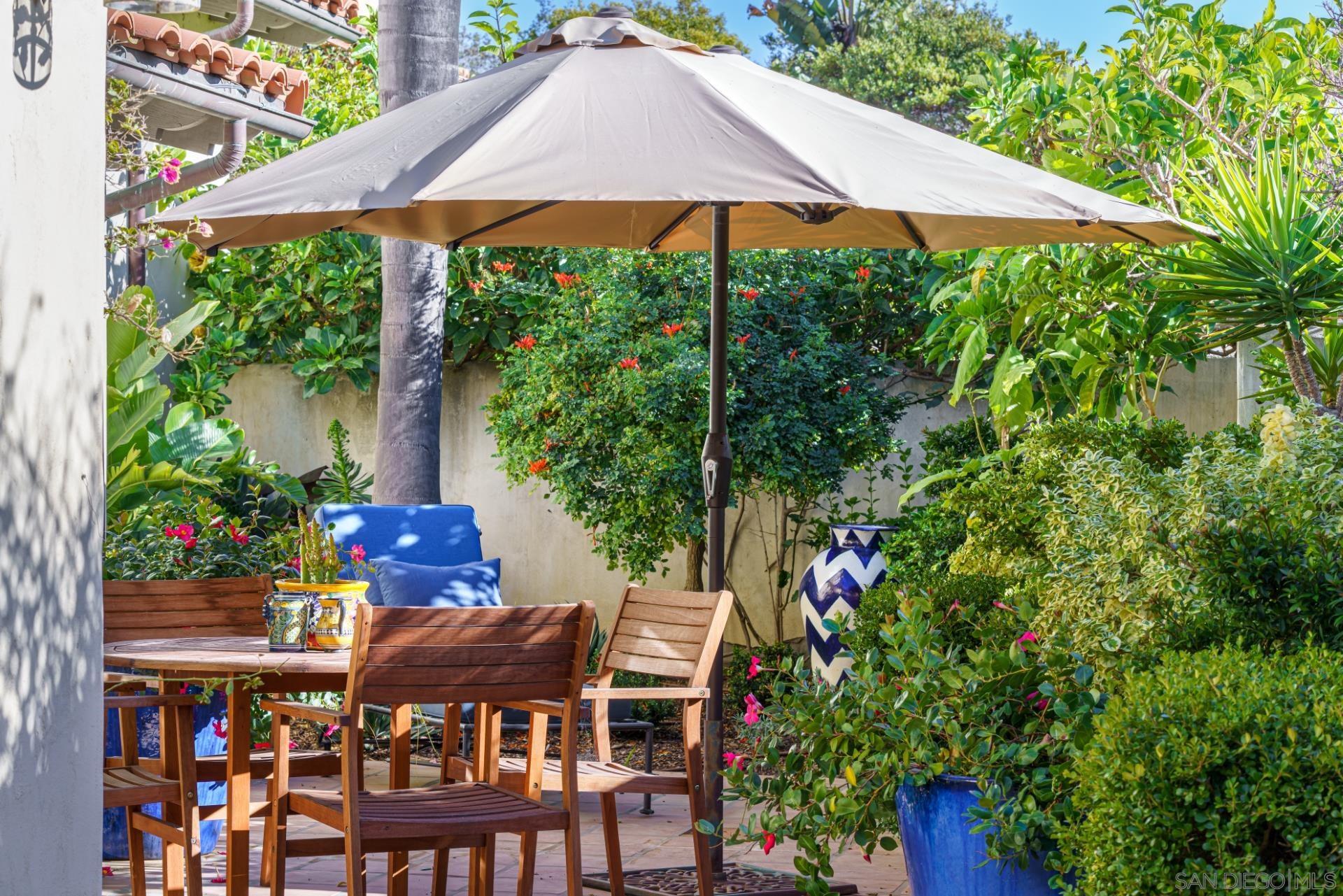 6174 El Tordo Rancho Santa Fe, CA 92067 - Photo 9 of 58 a patio with table and chairs under an umbrella