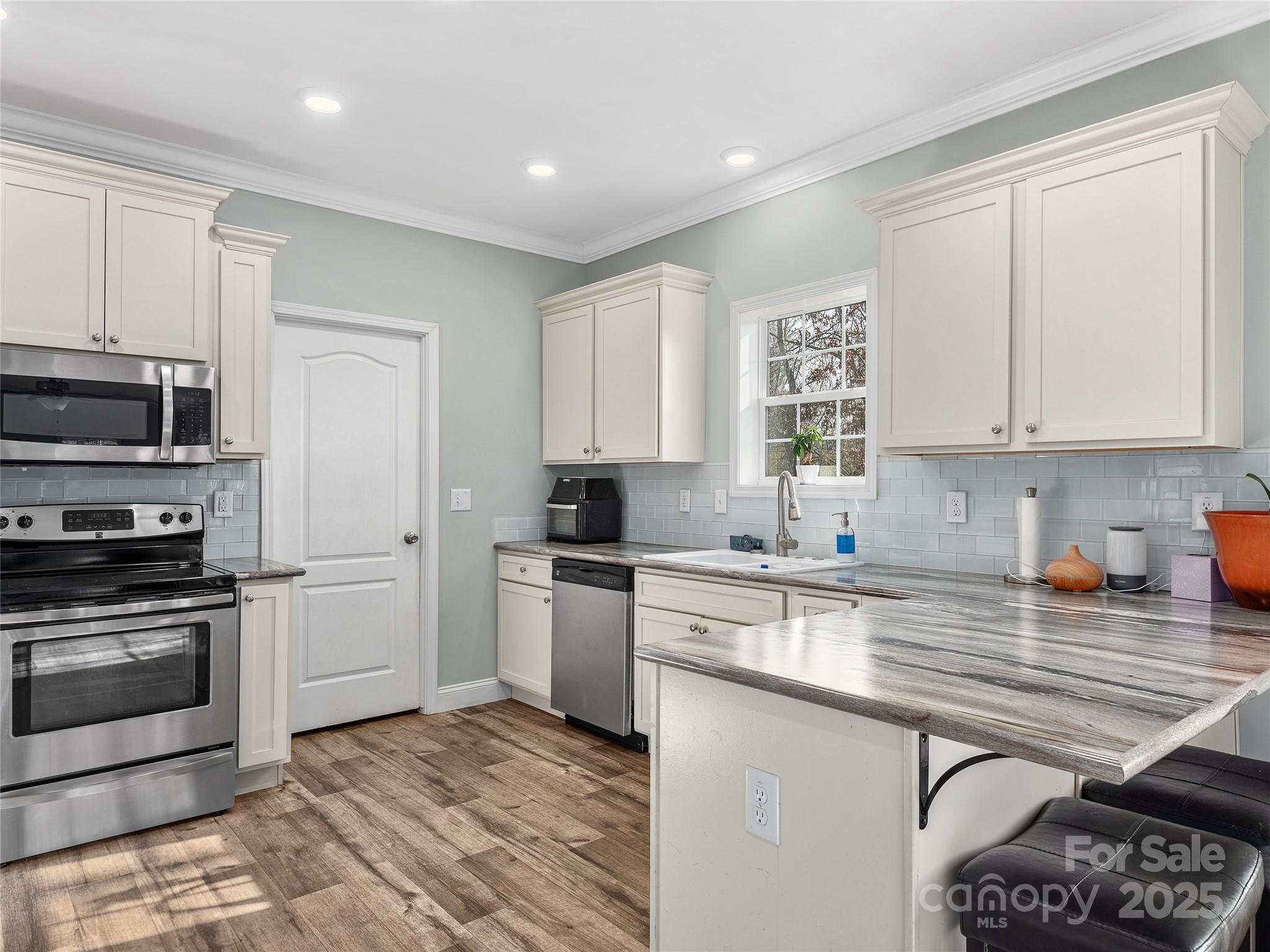 508 Fanning Bridge Road Fletcher, NC 28732 - Photo 9 of 21 a kitchen with stainless steel appliances granite countertop a stove a sink and a microwave
