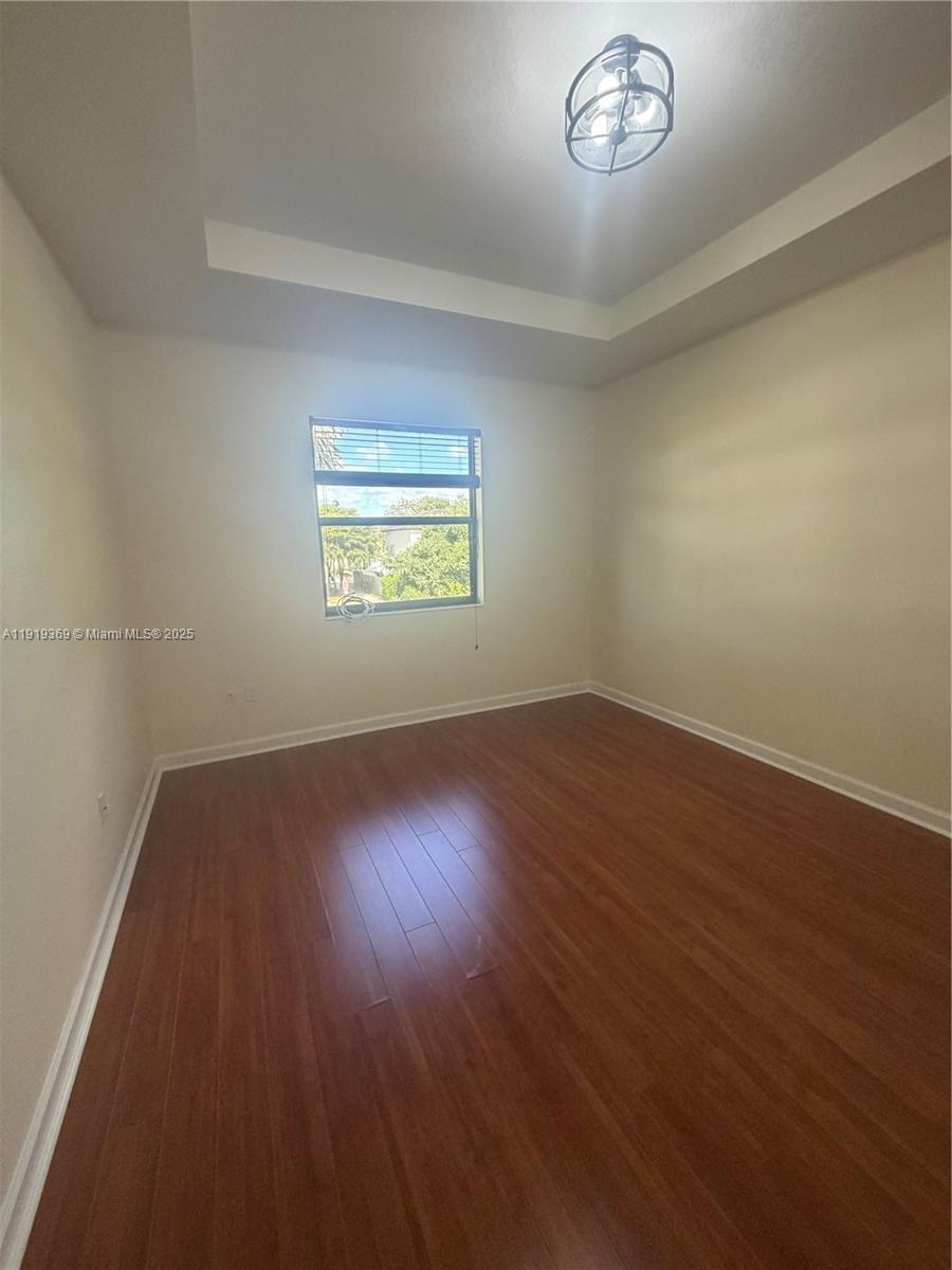 11347 Southwest 232nd Terrace Homestead, FL 33032 - Photo 11 of 26 an empty room with wooden floor and windows