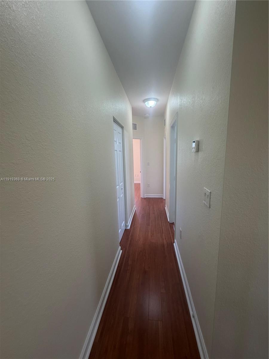 11347 Southwest 232nd Terrace Homestead, FL 33032 - Photo 16 of 26 a view of hallway with wooden floor