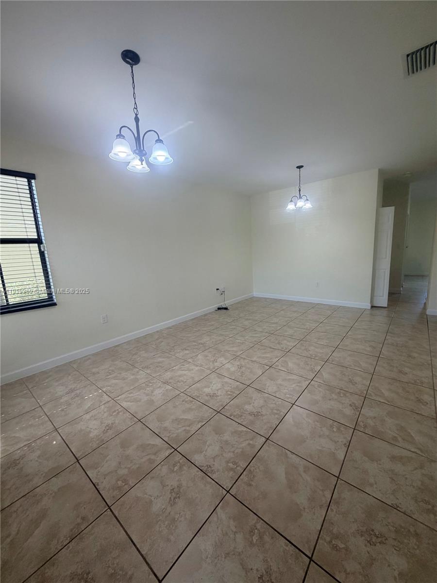 11347 Southwest 232nd Terrace Homestead, FL 33032 - Photo 2 of 26 a view of empty room with wooden floor and ceiling fan