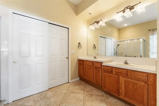 a spacious bathroom with a double vanity sink mirror and double