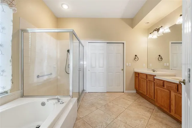a bathroom with a bathtub shower and double sink