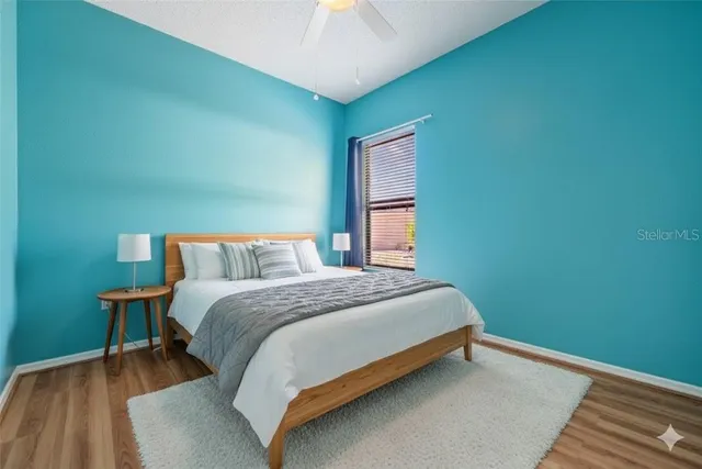 a bed sitting in a bedroom next to a lamp