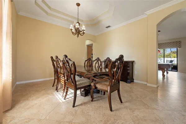 a view of a dining room with furniture and chandelier