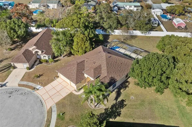 an aerial view of a house with a yard