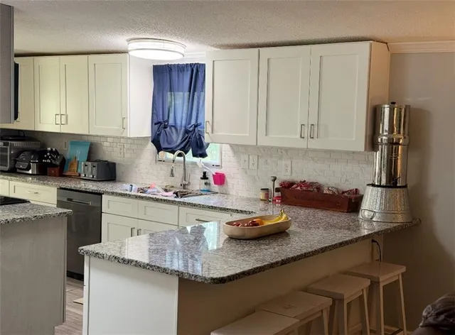 a kitchen with sink cabinets and microwave
