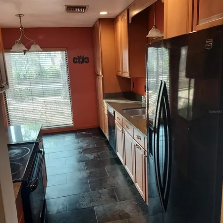 a white toilet and tub sitting next to a bathroom sink
