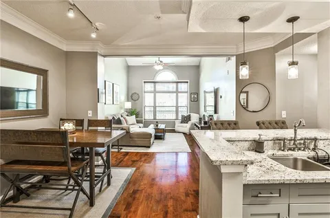 a living room with granite countertop lots of furniture and a large window