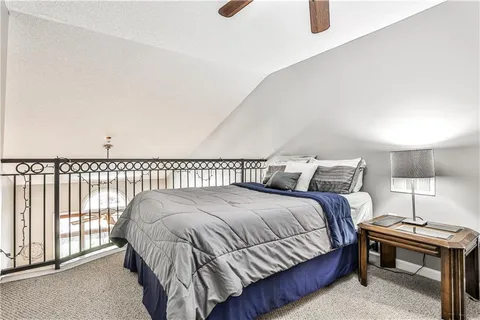 a bedroom with a bed and a lamp