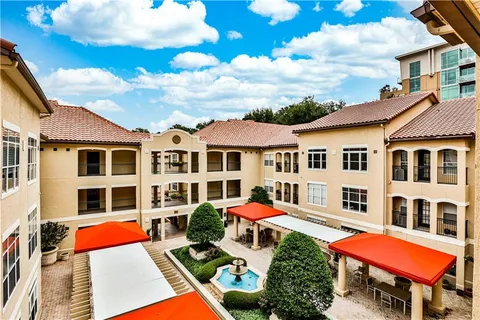 a front view of a residential apartment building with a yard