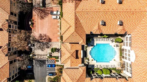 an aerial view of a house with swimming pool and sitting space