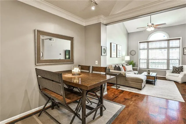 a dining room with furniture and wooden floor
