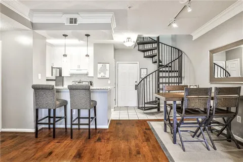 a dining room with furniture and wooden floor
