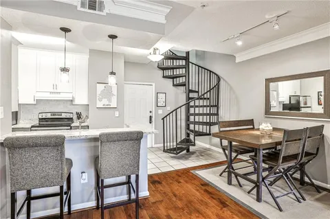 a dining room with furniture and wooden floor