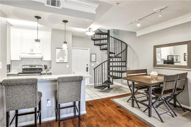 a kitchen with a sink a stove a table and chairs