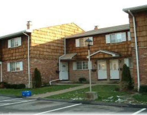 65 Patricia Road, Unit H Bridgeport, CT 06606 - Photo 1 of 1 a view of a white house next to a yard
