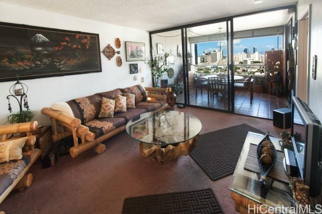 a living room with furniture and a floor to ceiling window